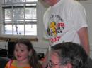 Hope Hargis, 5-1/2 years old, says her ABCs, radio style, to the delight of the K4PJ FD dinner group.  Grandpa Charlie, K4LF, (standing) is her coach.